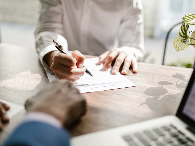 Professional notary signing documents at desk in Taylor, Texas